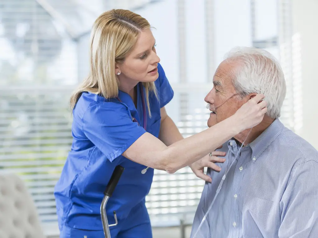 nurse checks patients blood pressure